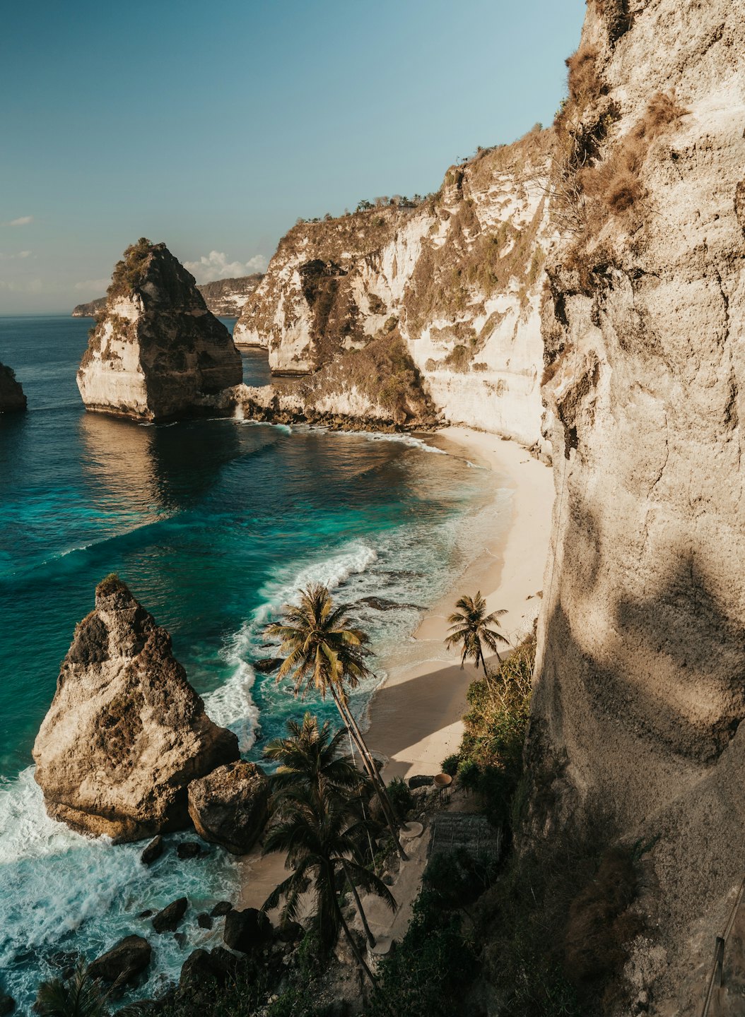 Secluded beach with limestone cliffs and turquoise water.